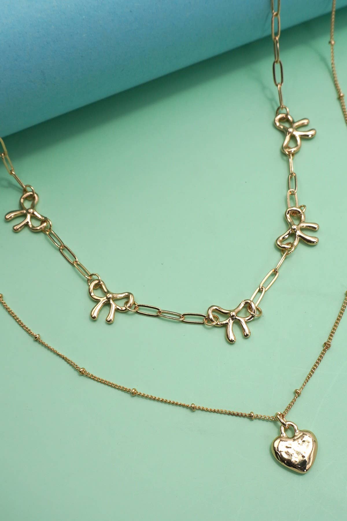 DOUBLE LAYER MULTI BOW WITH HEART CHARM NECKLACE | 80N91660